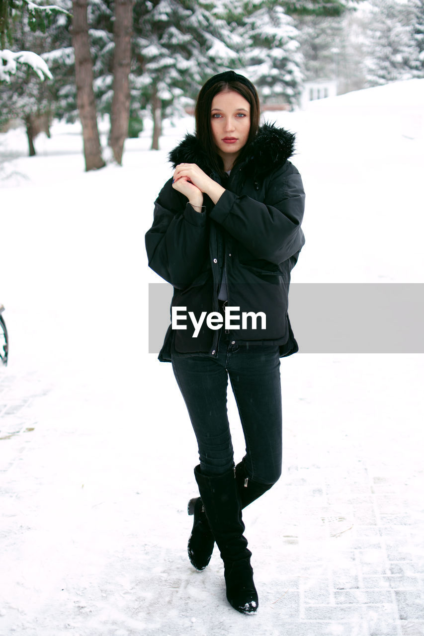 Young woman standing on snow