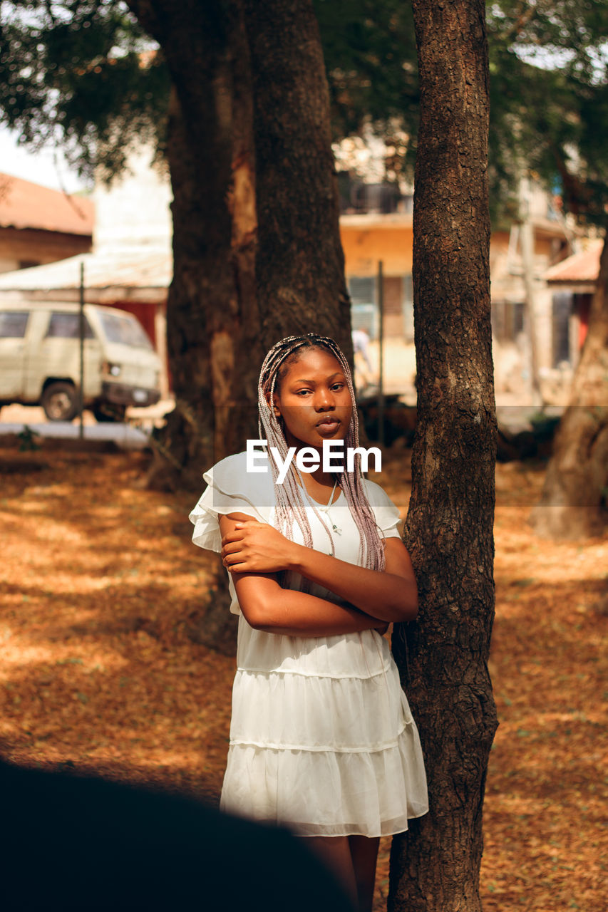 Girl standing on tree trunk