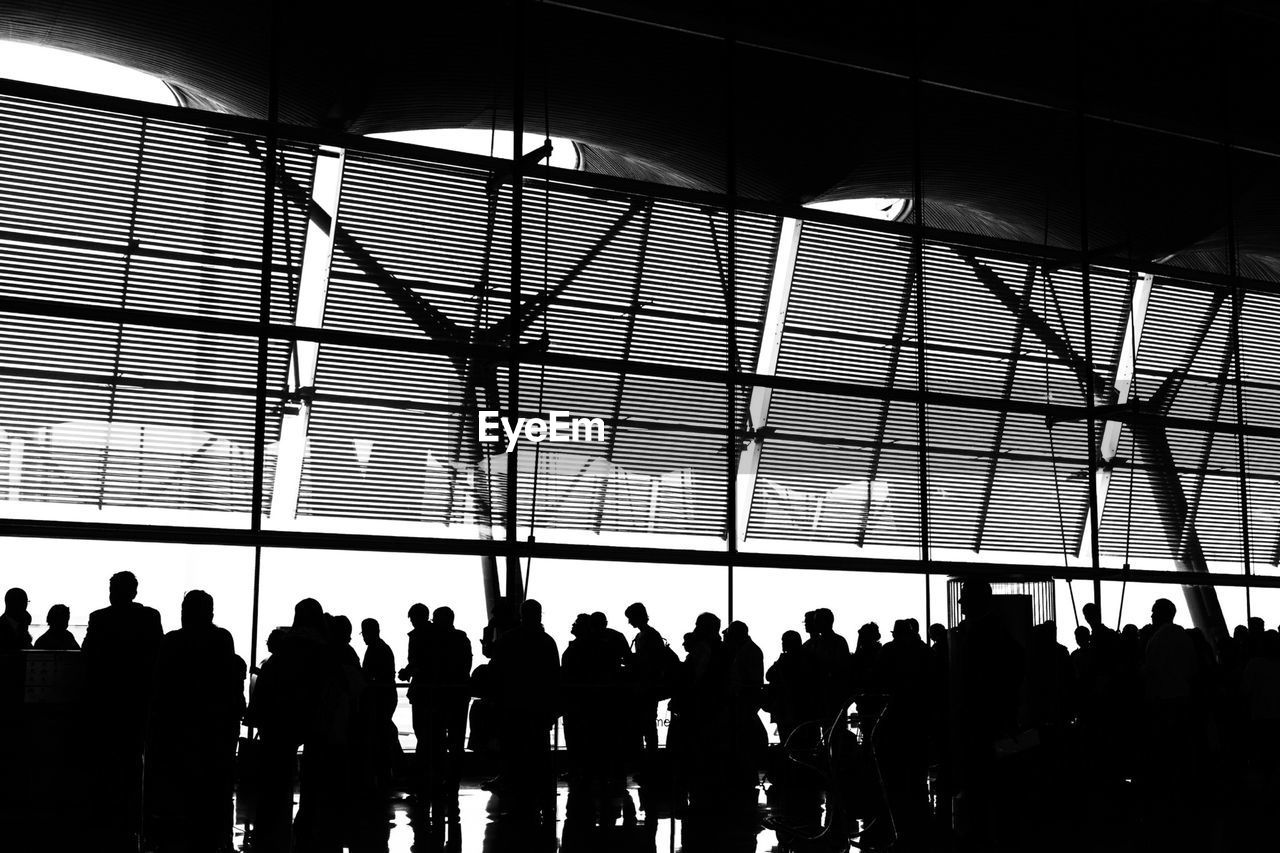 Silhouette people standing in airport