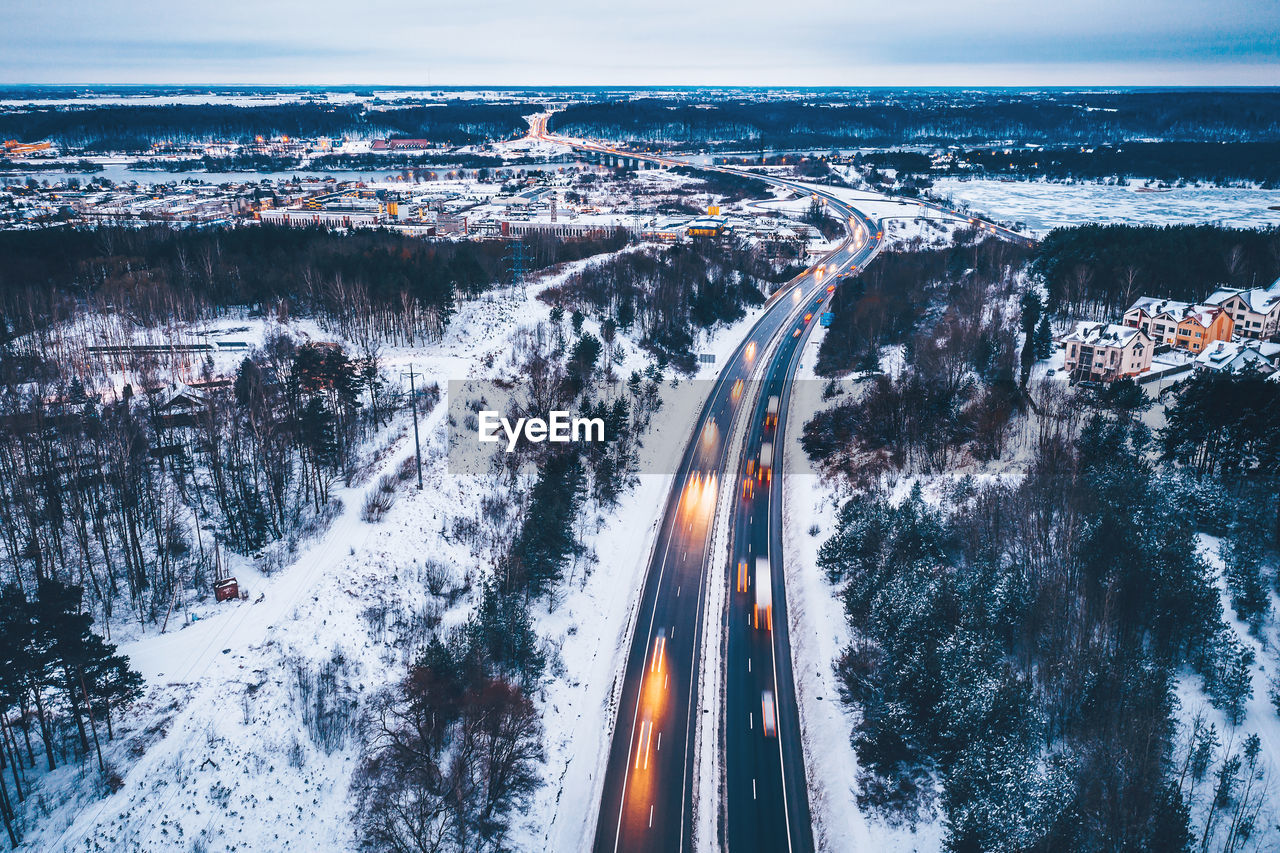 Aerial view of road on snow covered field