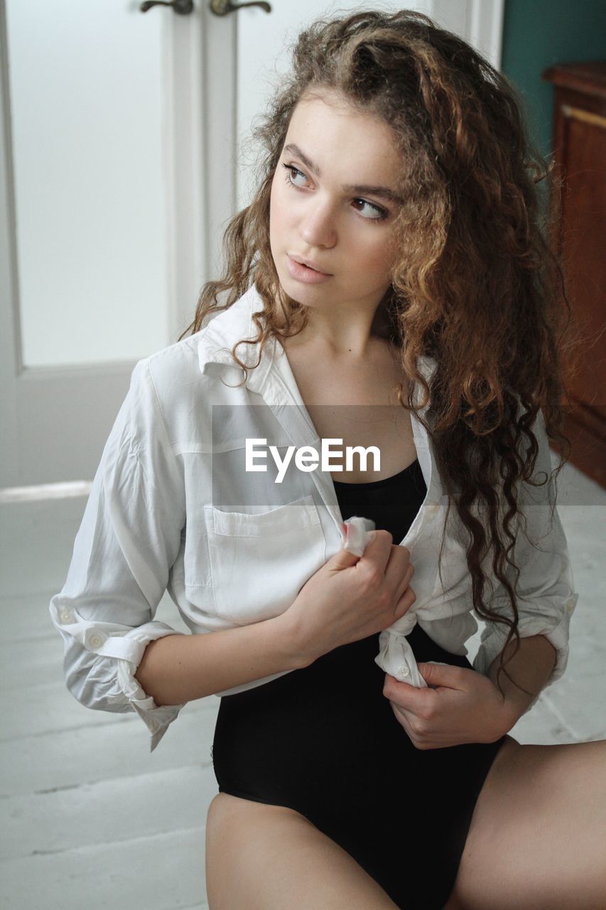 Portrait of young woman sitting at home