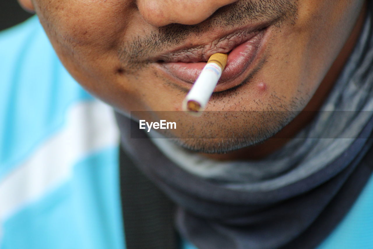 Close-up of man smoking cigarette