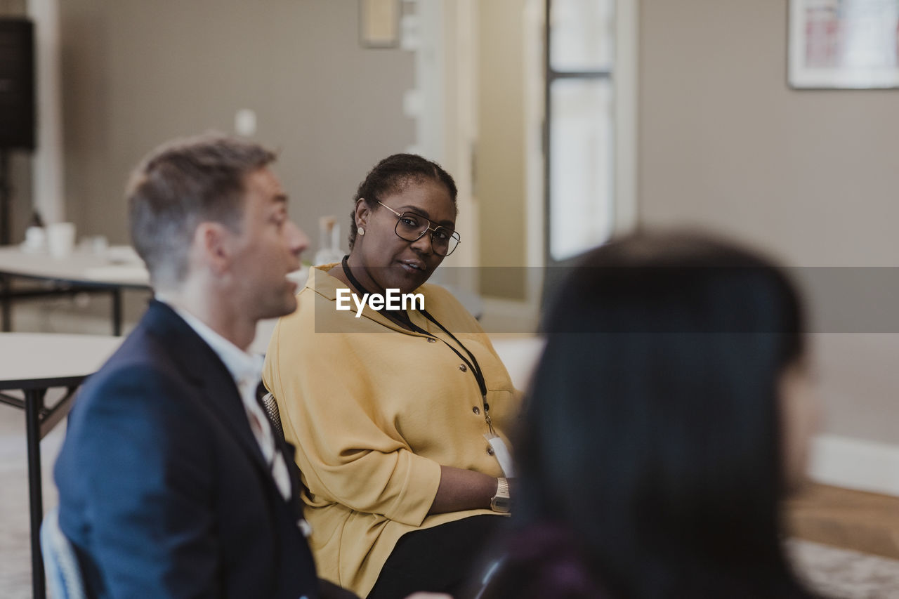 Businessman discussing with female colleagues at corporate office