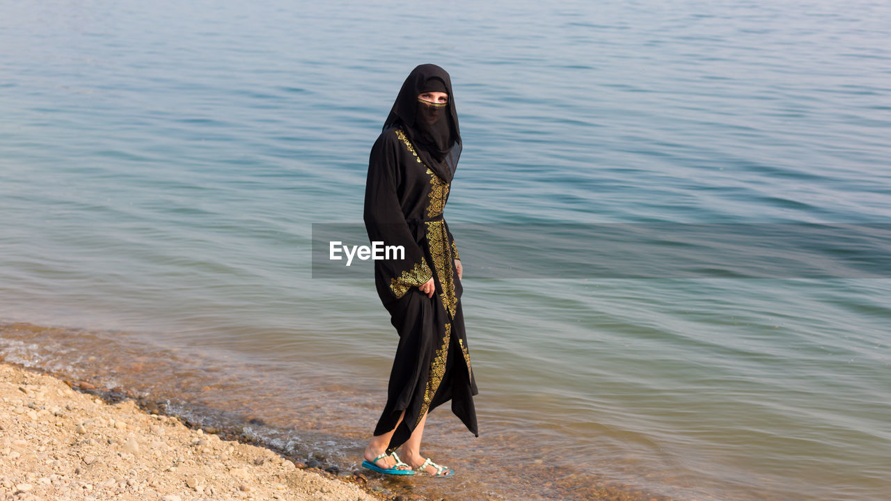 Full length of woman standing on beach