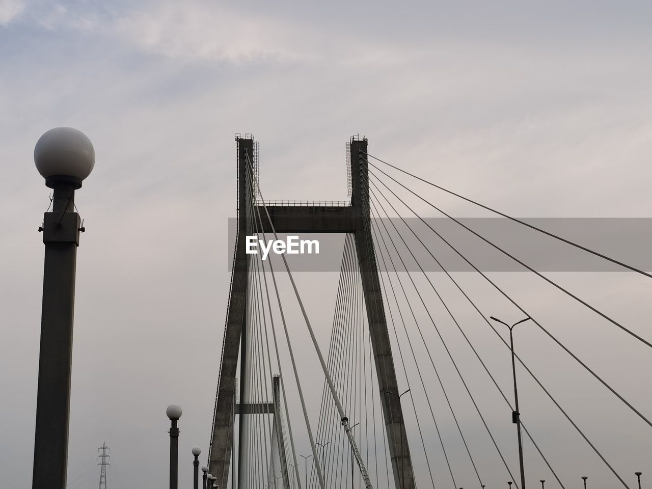 LOW ANGLE VIEW OF BRIDGE AGAINST SKY IN CITY