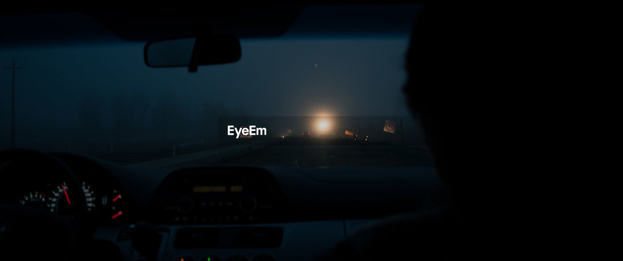 SILHOUETTE OF CAR ON WINDSHIELD OF BUS