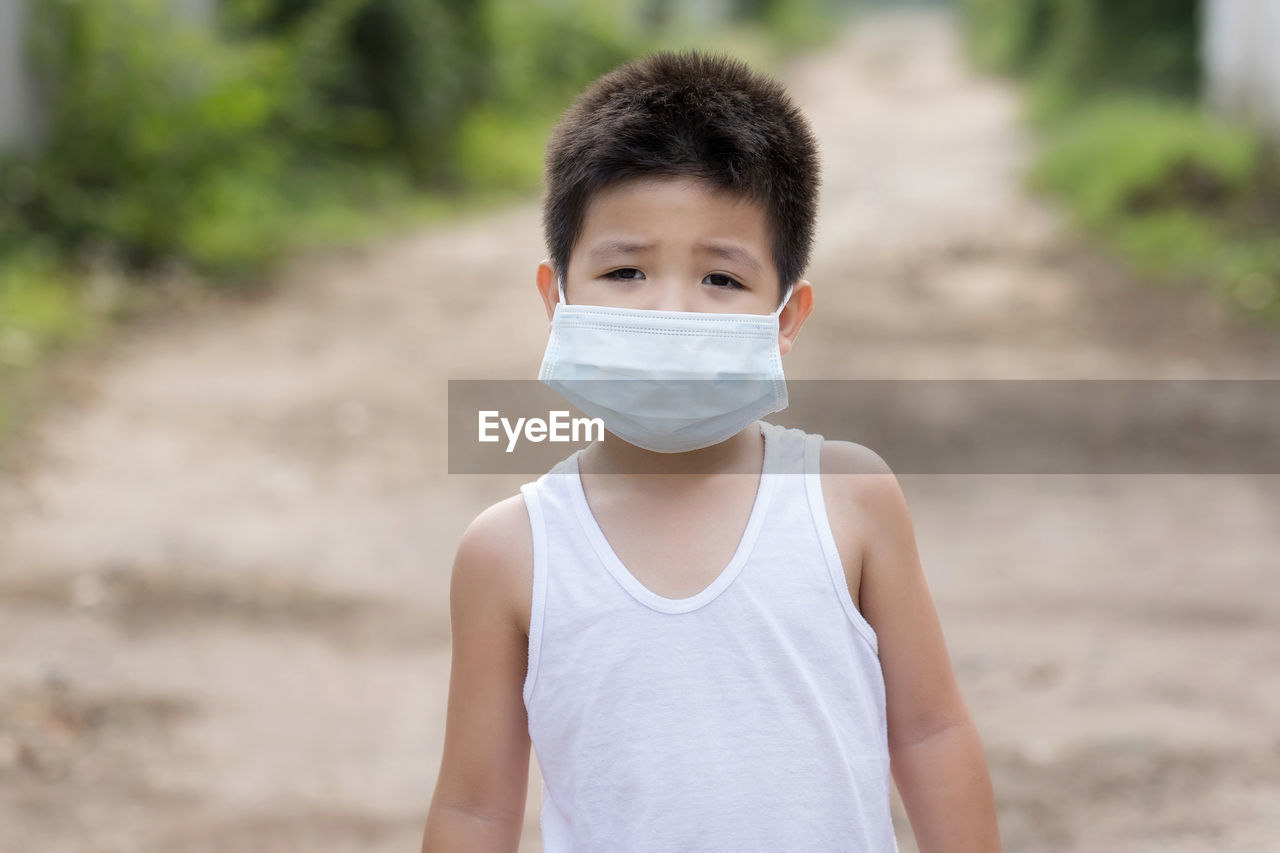 Portrait of boy standing on land