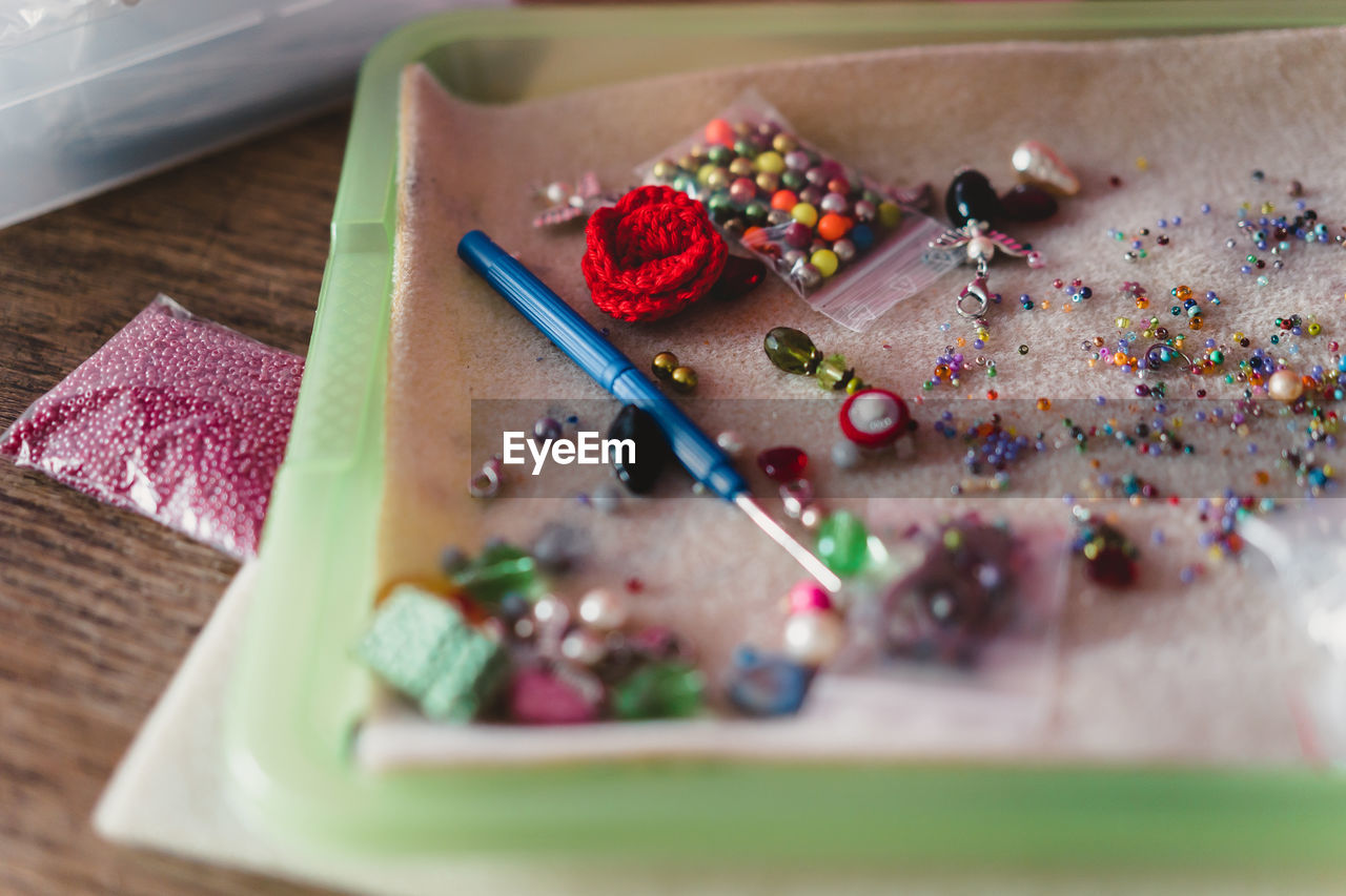 High angle view of multi colored sewing items on table