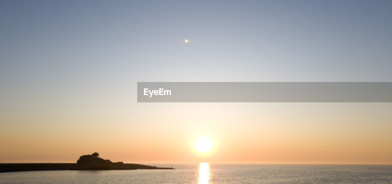 Scenic view of sea against sky at sunset