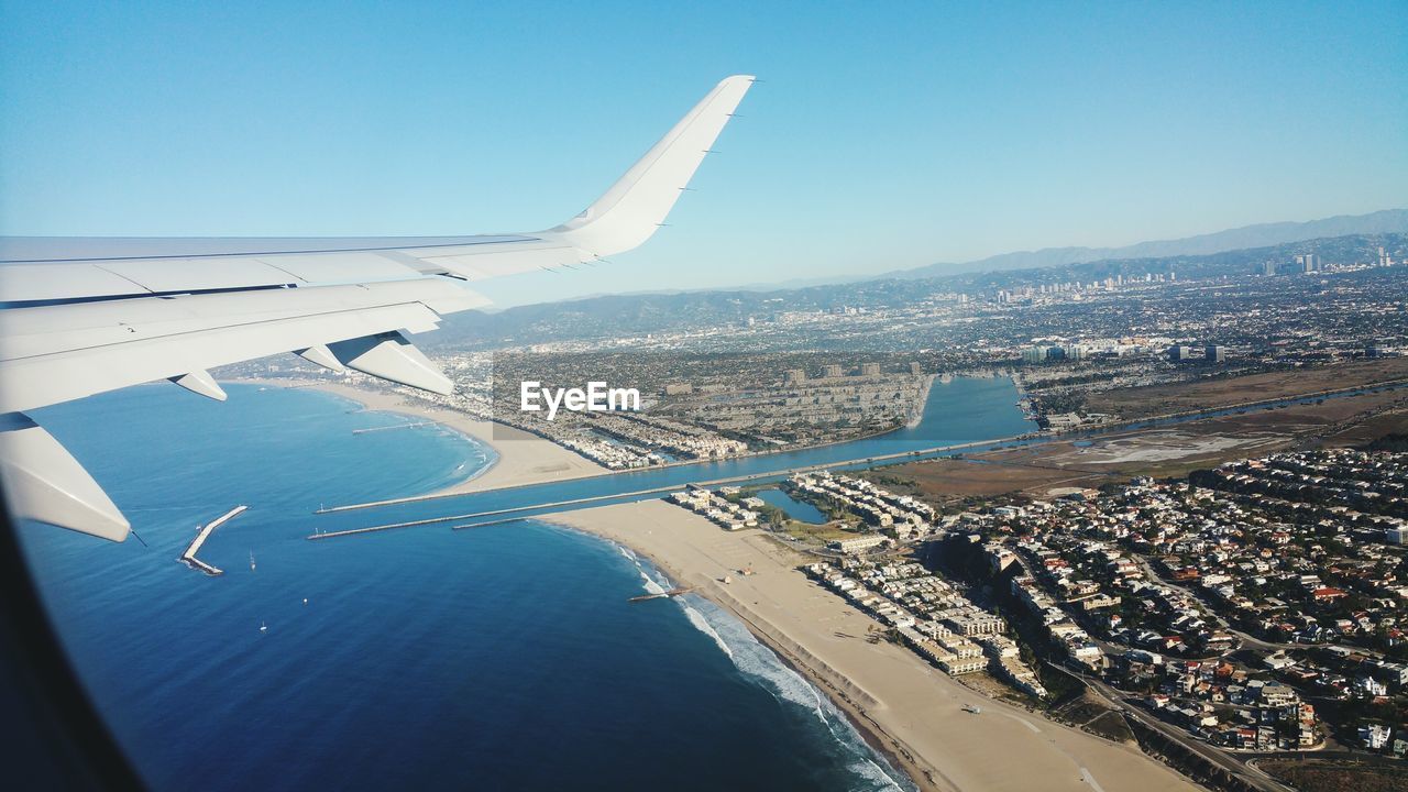 Cropped image of airplane against blue sky