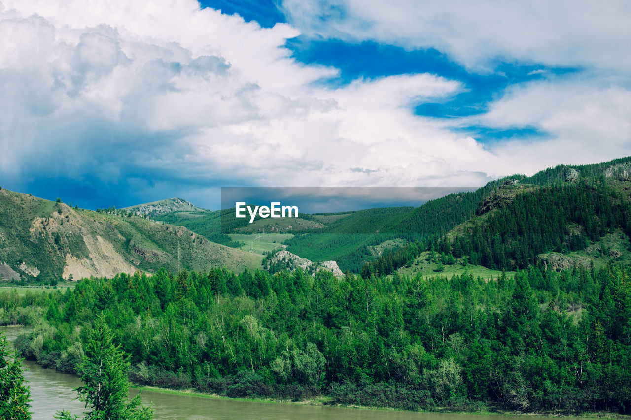 Scenic view of field and mountains against sky