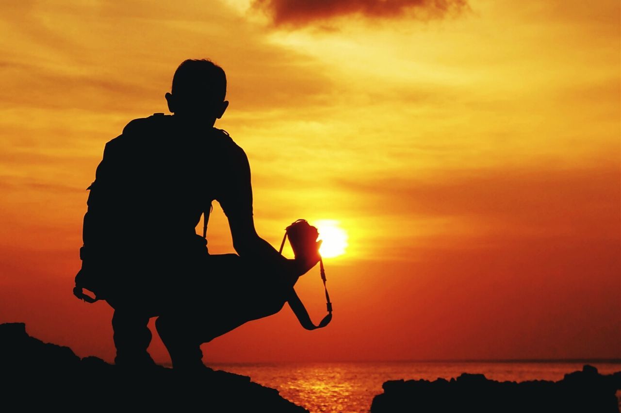 Rear view of person on beach at sunset