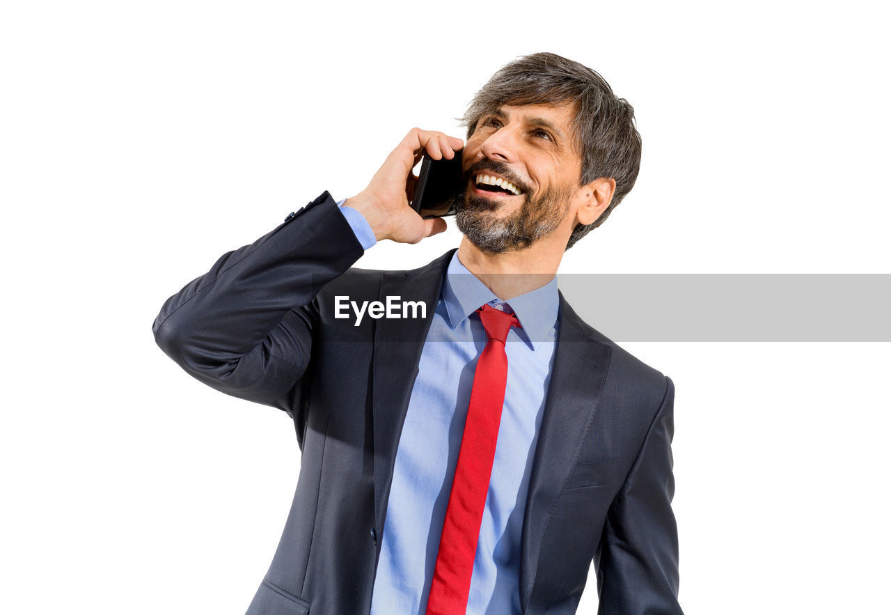 MID ADULT MAN USING MOBILE PHONE