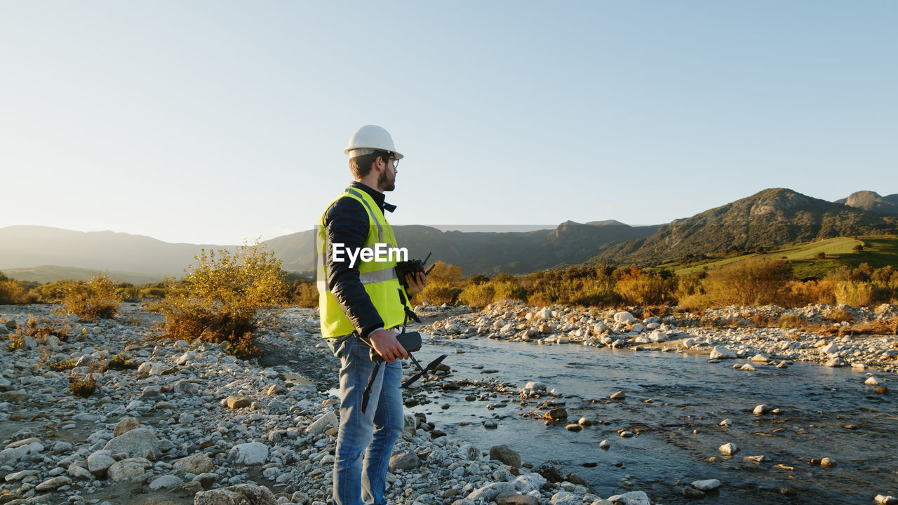 Engineer with drone check the state of the environment and the territory