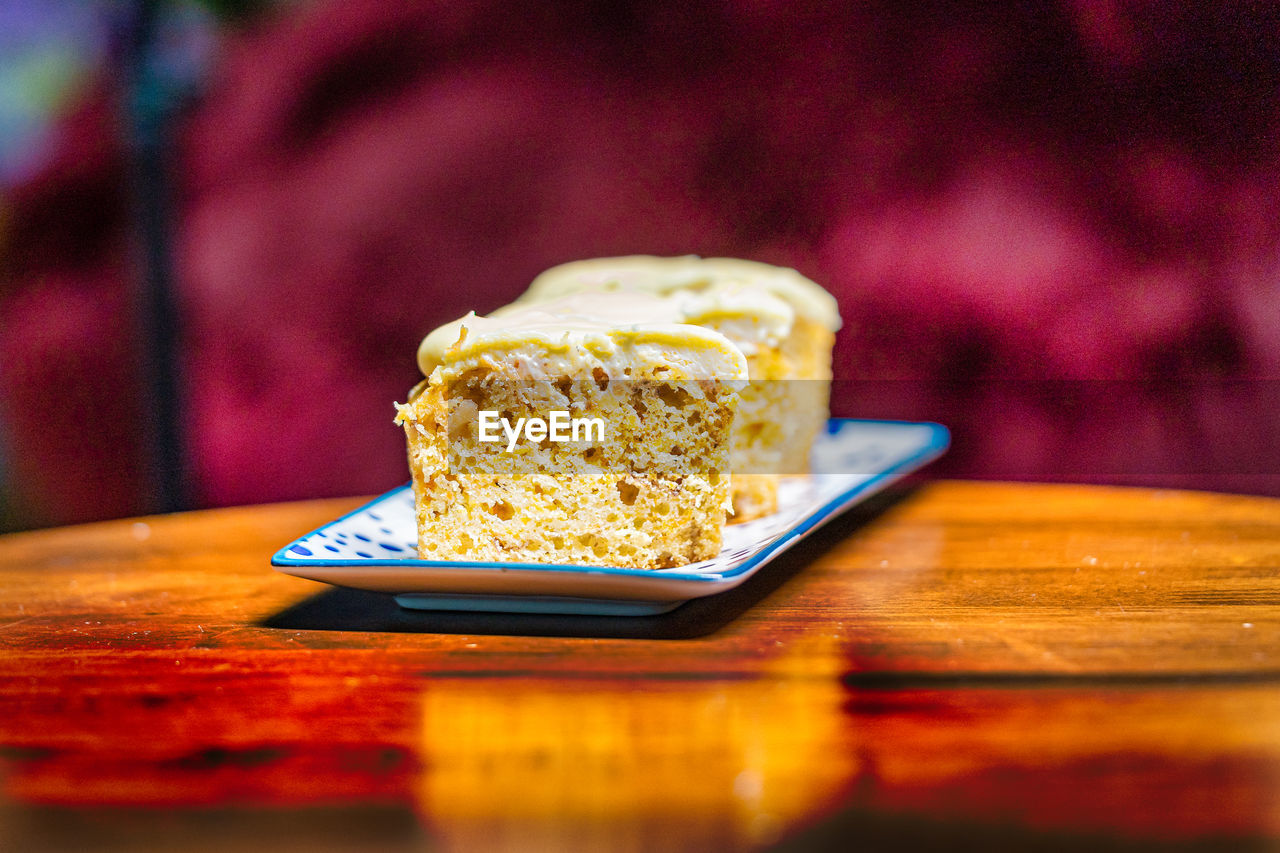 Slices of carrot cake in a plate on a wooden a table