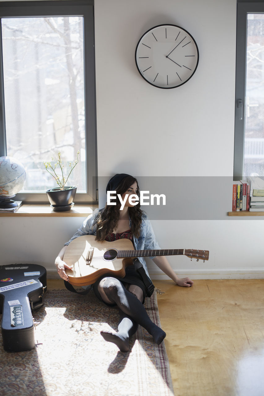Young woman playing an acoustic guitar