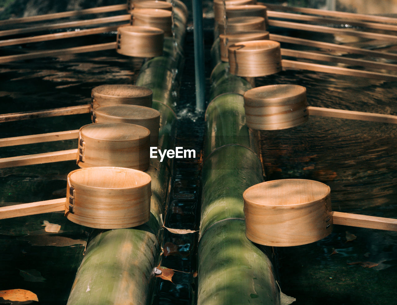 High angle view of wooden pipes in water