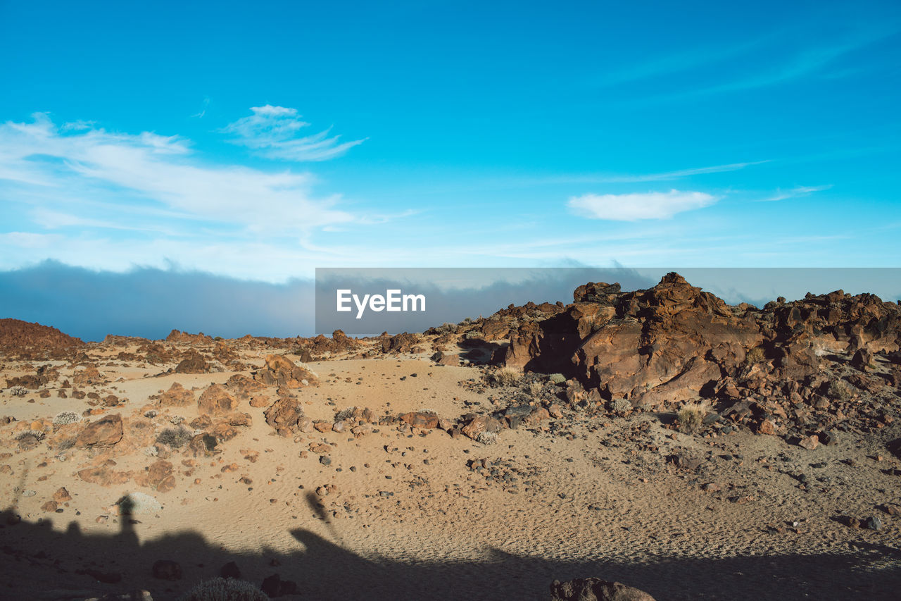 Rock formations in desert against blue sky