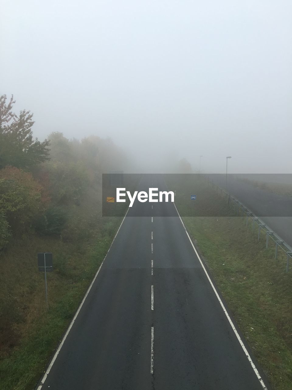 High angle view of road amidst grassy field