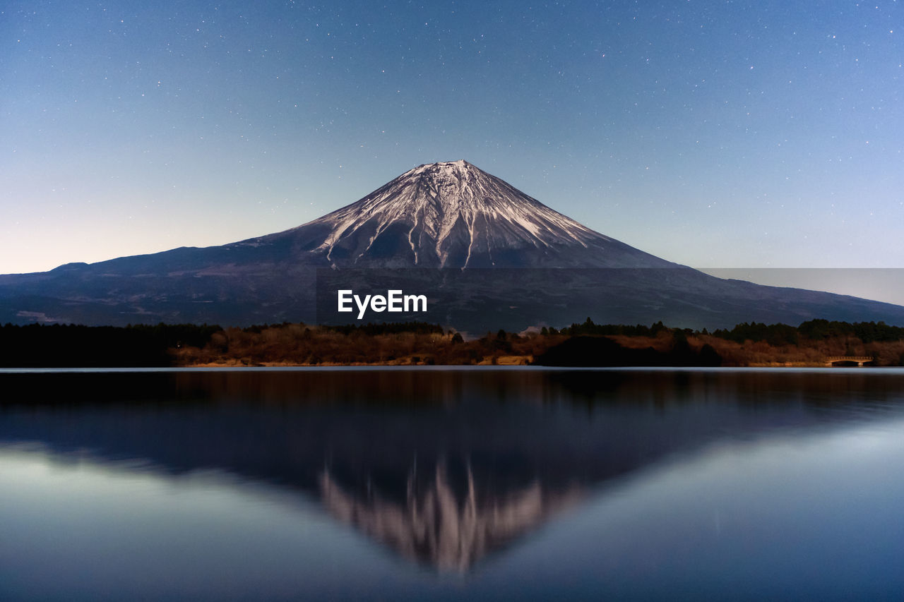 scenic view of mountains against sky at night