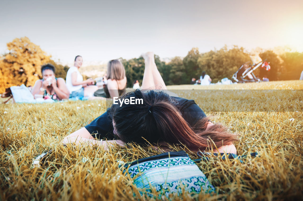 WOMEN RELAXING ON FIELD