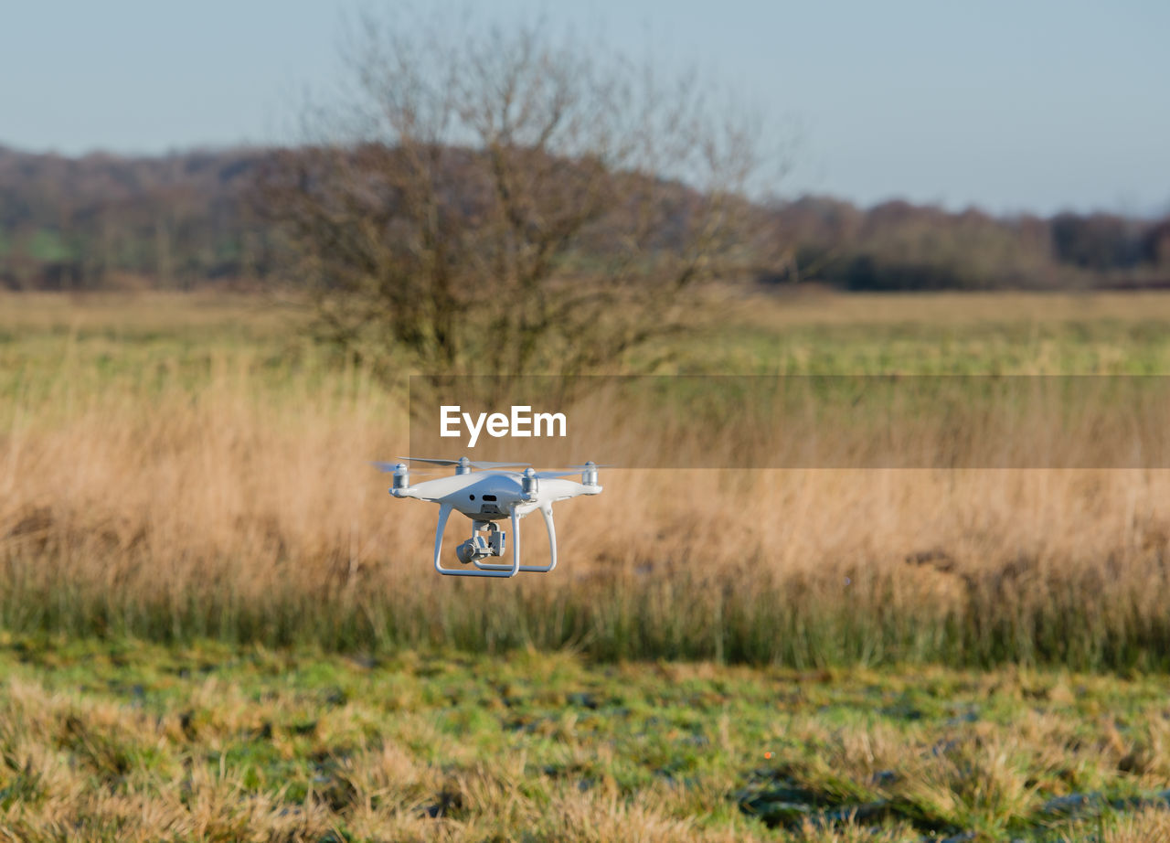 Drone flying over field