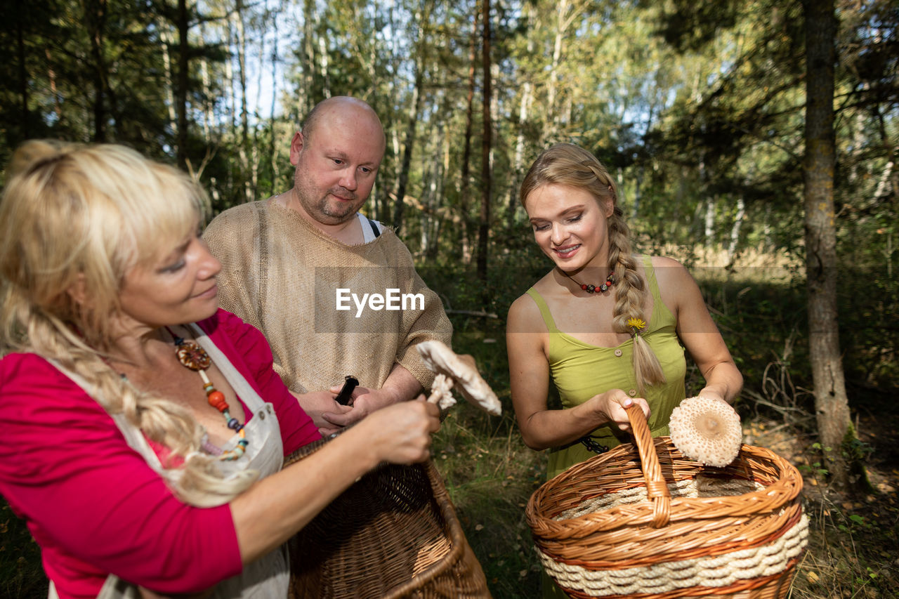 portrait of smiling friends sitting in basket