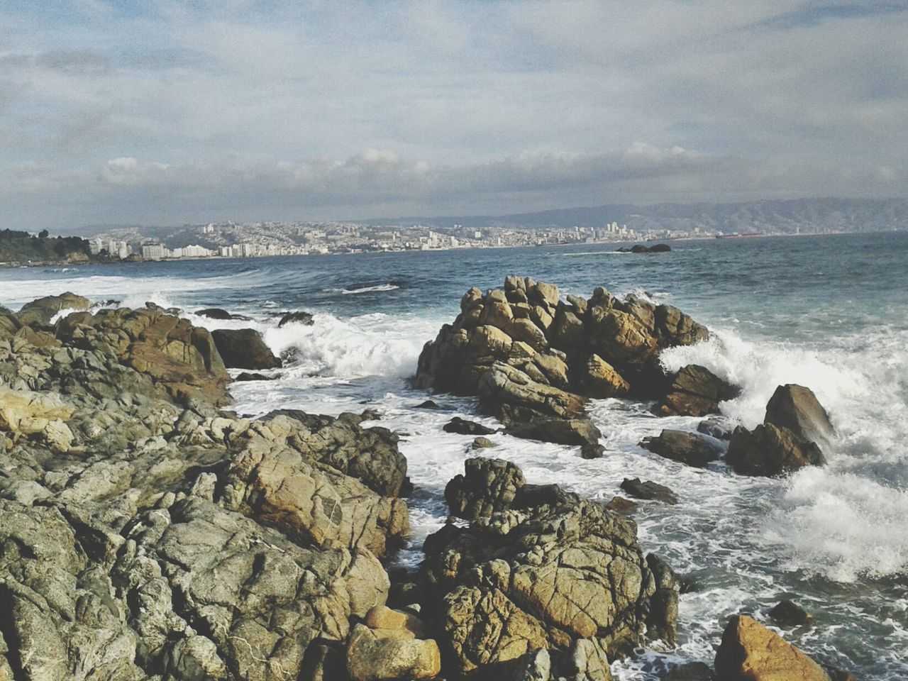 Rocks in sea against sky