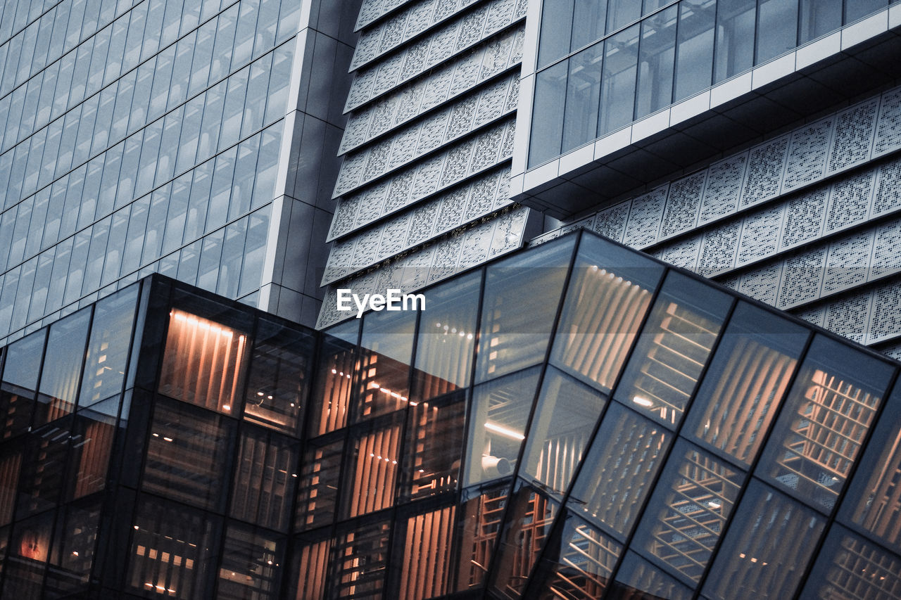 Low angle view of modern glass building in city