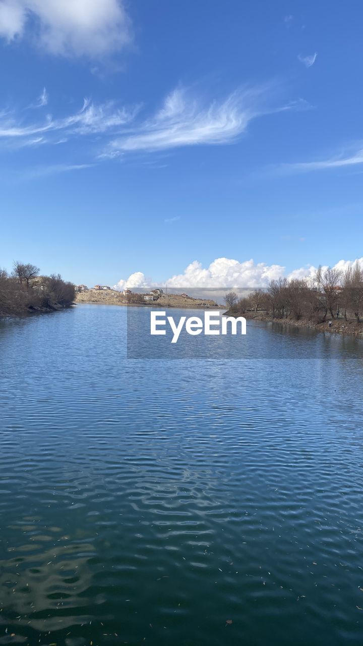 SCENIC VIEW OF LAKE BY TREES AGAINST SKY