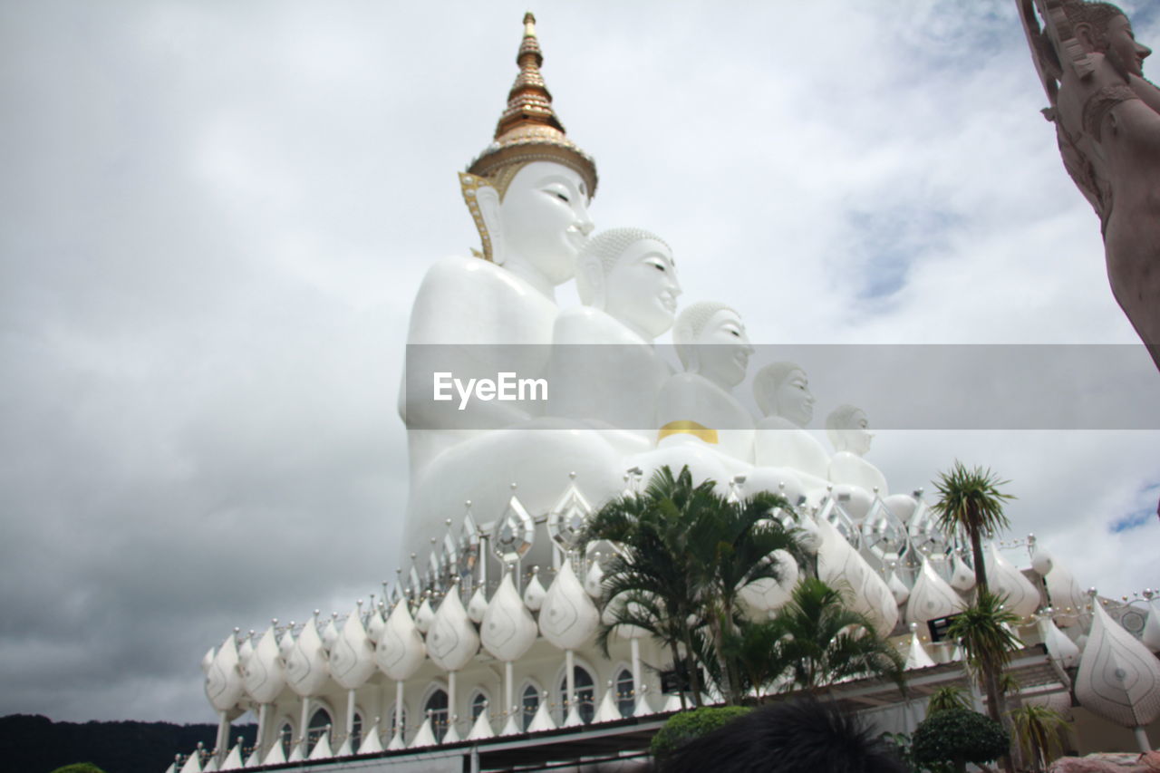 LOW ANGLE VIEW OF STATUE AGAINST TREES AND BUILDING