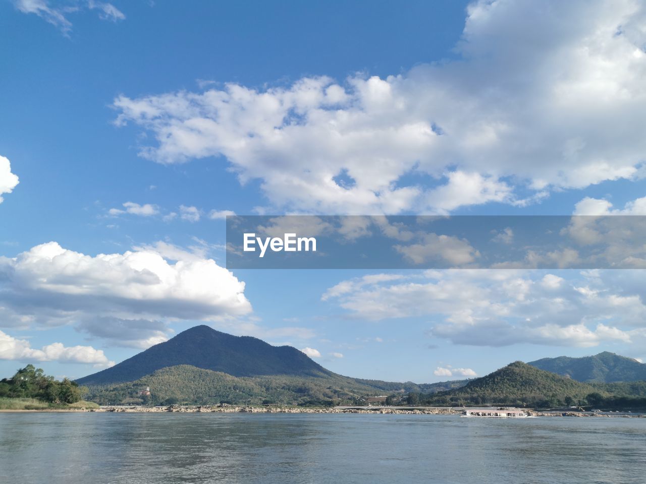 Scenic view of lake against cloudy sky