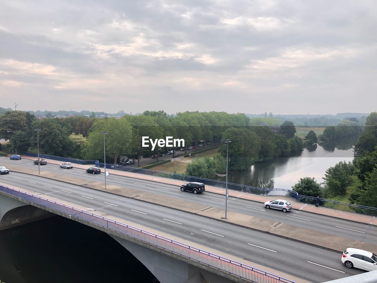 HIGH ANGLE VIEW OF BRIDGE ON ROAD AGAINST SKY