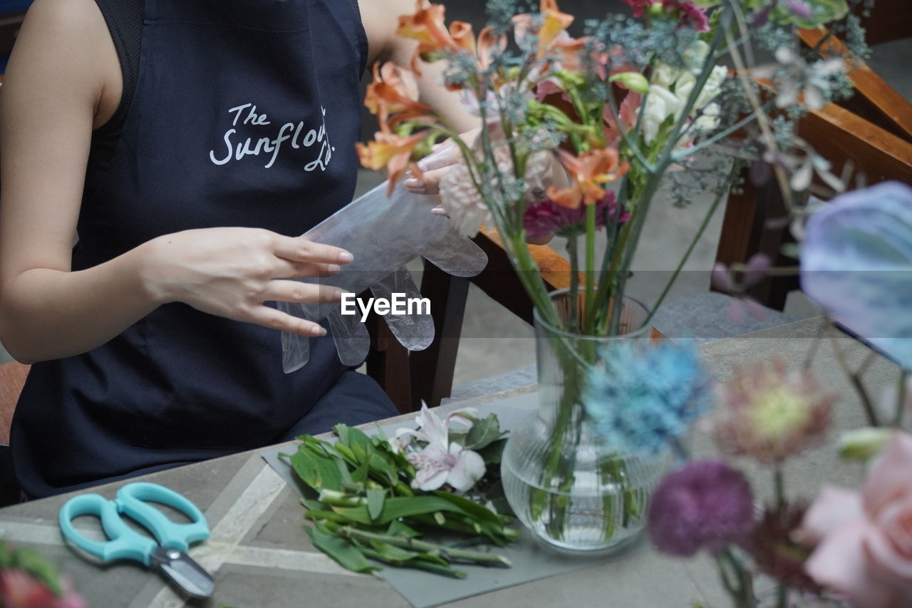 Midsection of woman holding bouquet