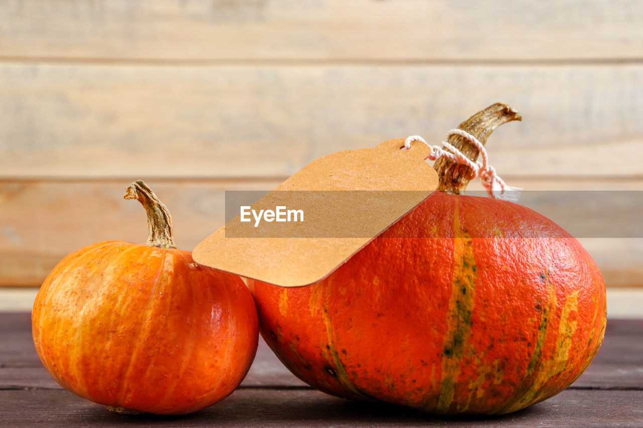 food and drink, food, healthy eating, produce, wood, wellbeing, freshness, fruit, no people, pumpkin, orange color, vegetable, still life photography, indoors, still life, autumn, close-up, celebration, table, studio shot, focus on foreground, plant, organic, nature