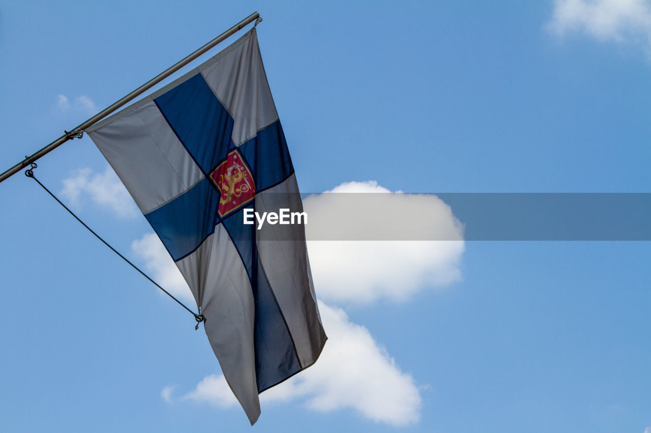 sky, flag, blue, patriotism, wind, cloud, nature, environment, low angle view, day, no people, outdoors, symbol, pole, independence