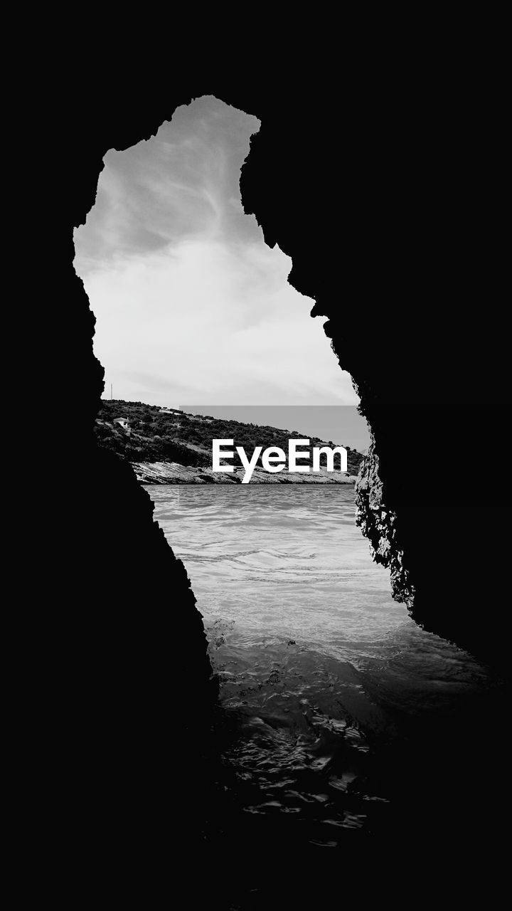 Sea against sky seen through cave