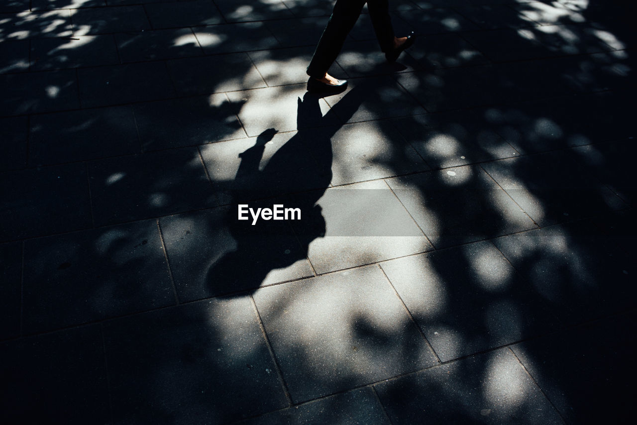 High angle view of woman walking on footpath