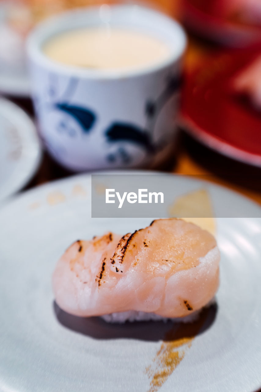 CLOSE-UP OF COFFEE CUP AND CAKE