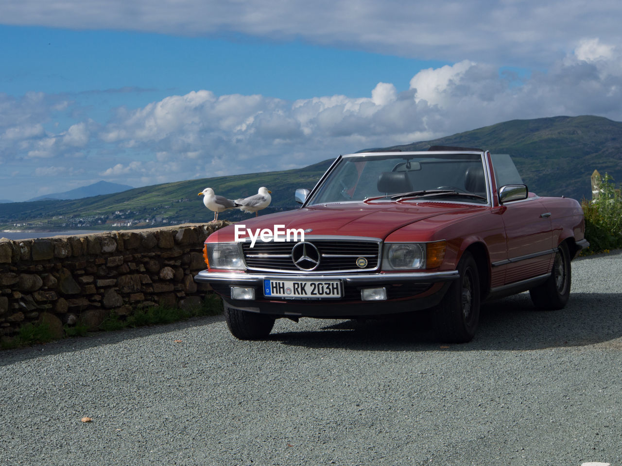 VINTAGE CAR AGAINST SKY