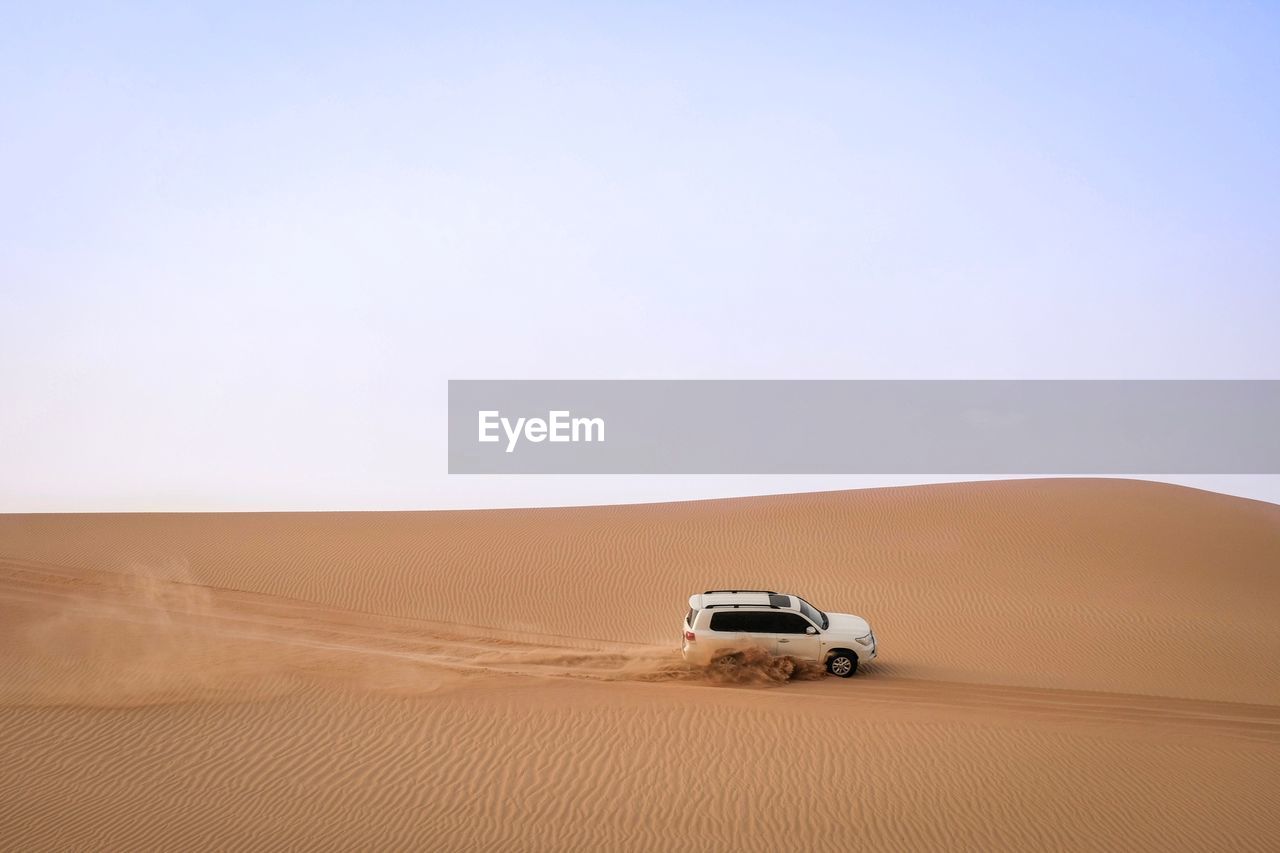 VIEW OF CAR ON DESERT