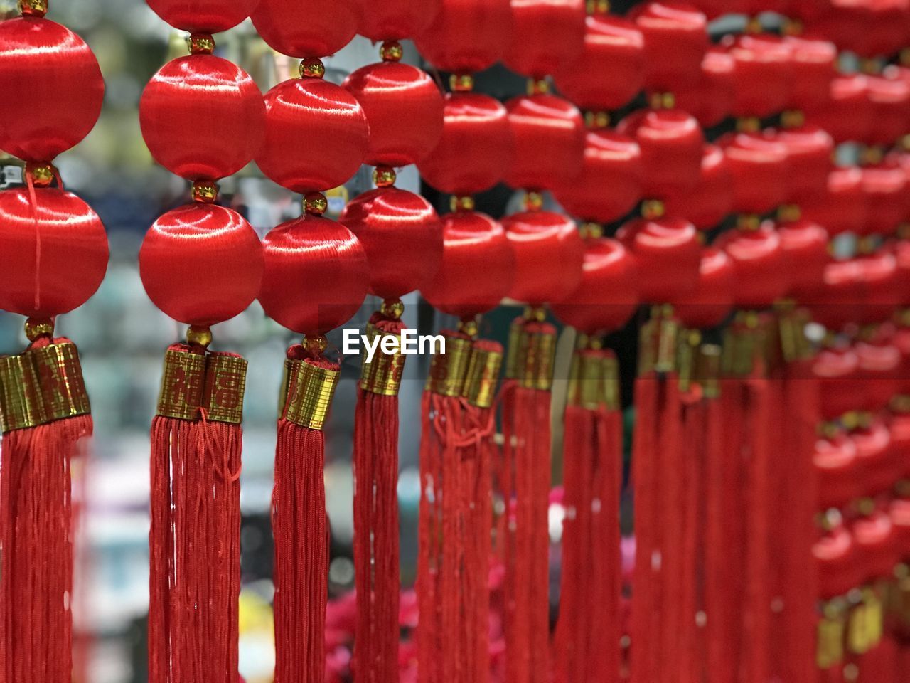 CLOSE-UP OF RED BELL HANGING IN ROW