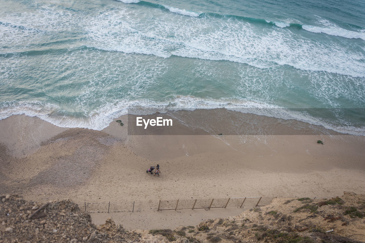 High angle view of people walking on beach