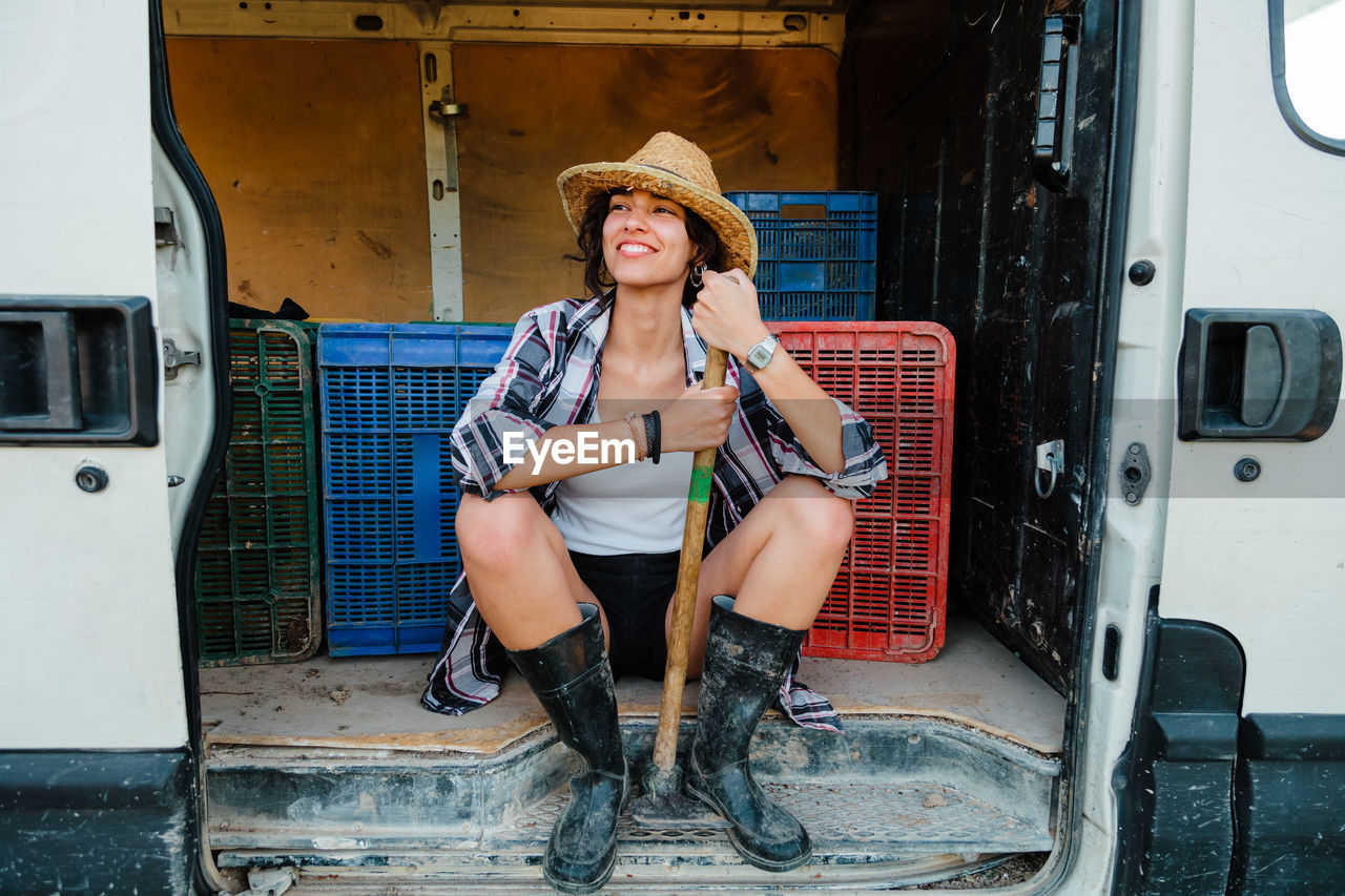 Full length of woman sitting in van