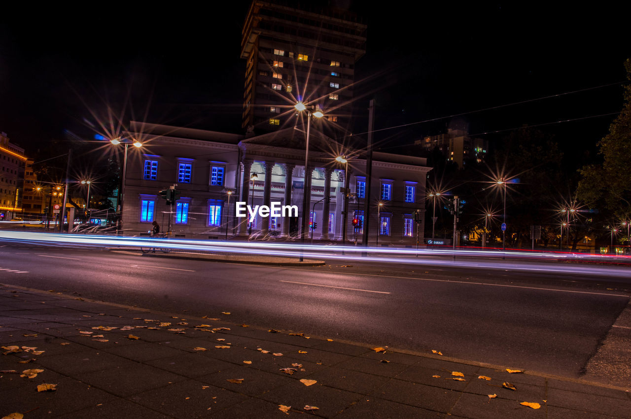 LIGHT TRAILS ON ROAD AT NIGHT