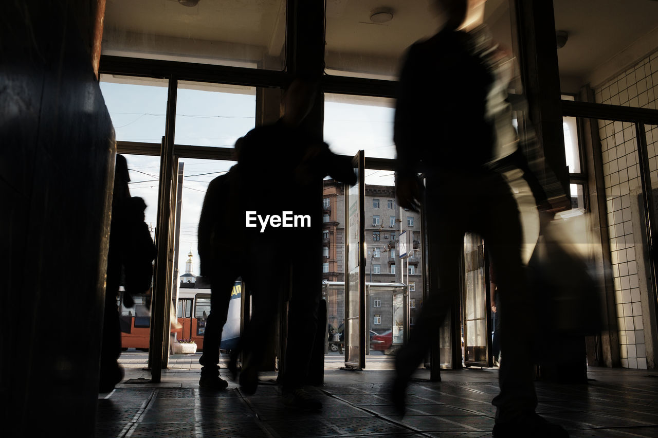 Blurred motion of people walking at subway station lobby