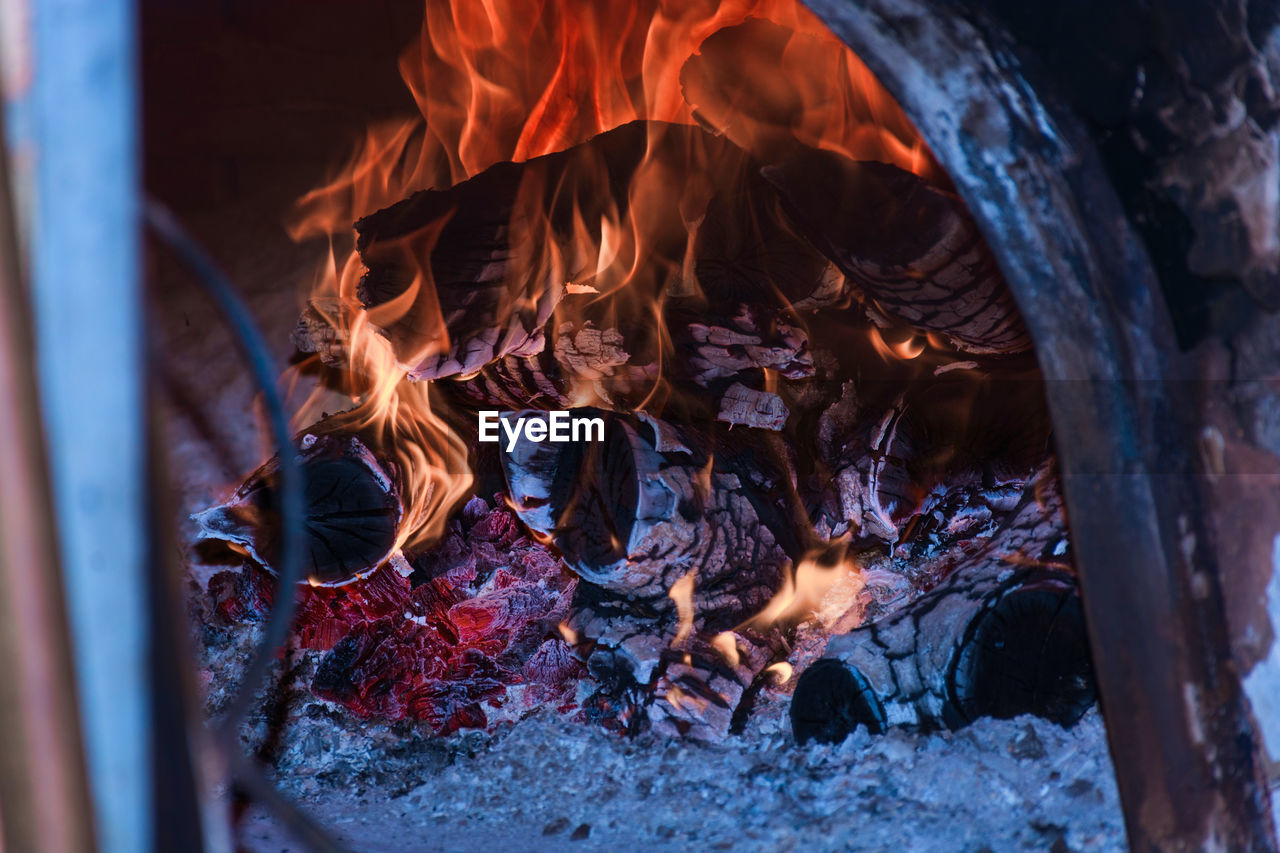 CLOSE-UP OF BONFIRE IN LOG