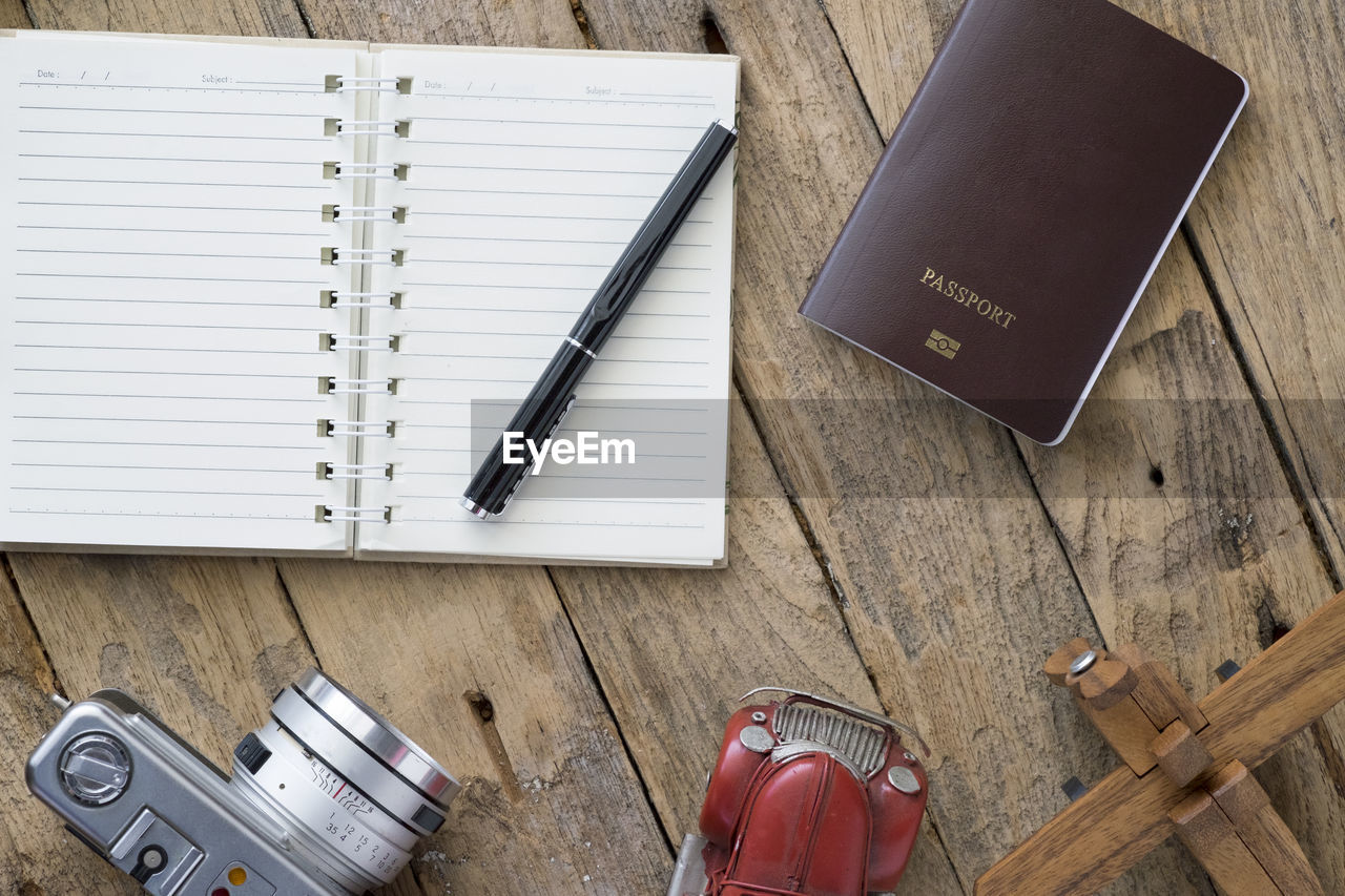 Diary with camera and toy car on table