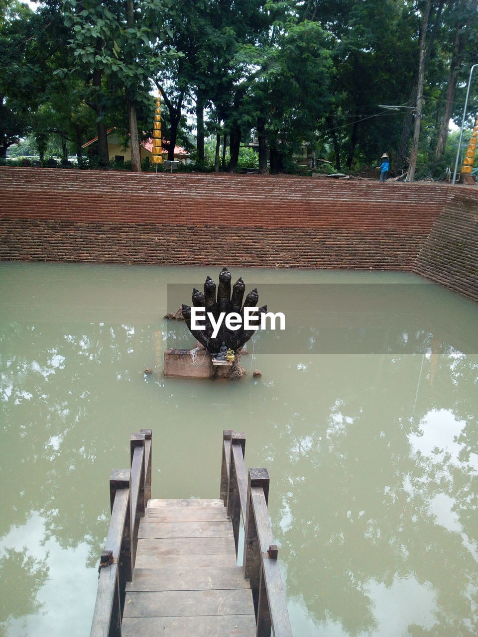 FOOTBRIDGE OVER RIVER AMIDST TREES