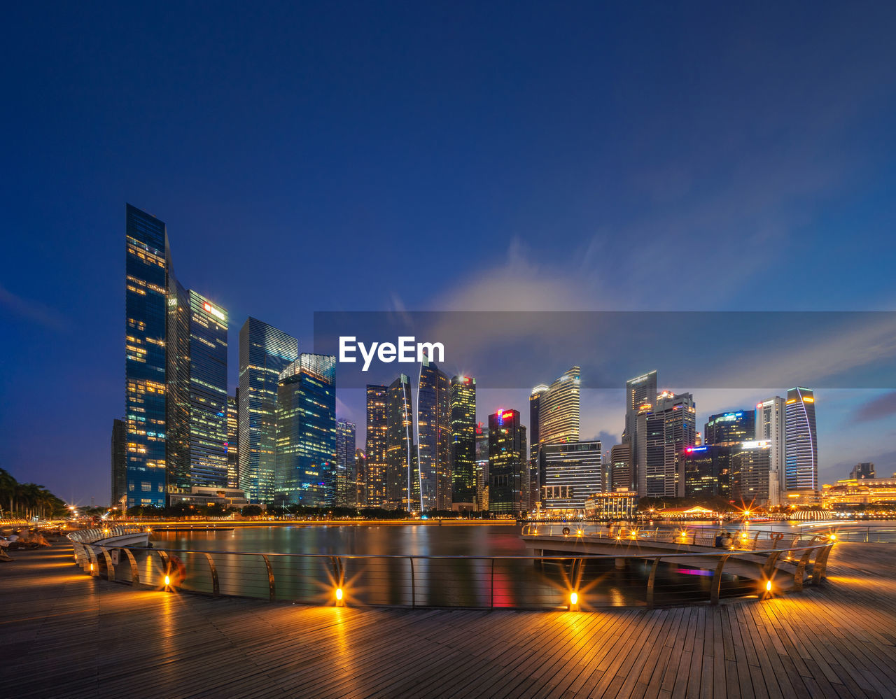 Illuminated buildings against sky at night